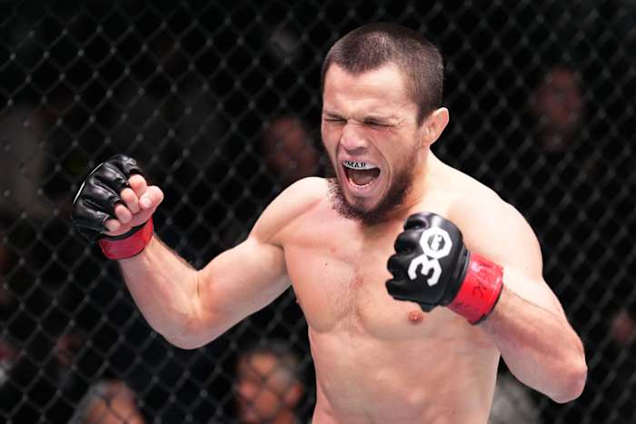 Umar Nurmagomedov celebrates a victory inside the UFC Octagon.